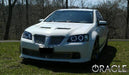 Three quarters view of a Pontiac G8 with white LED headlight halo rings.