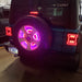 Rear view of a Jeep with pink LED Illuminated Spare Tire Wheel Ring Third Brake Light installed.
