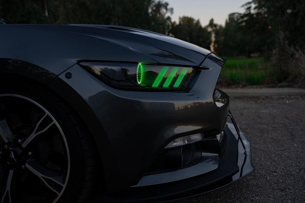 Close-up of green headlight halo and DRLs installed on a Ford Mustang.