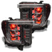 GMC Sierra headlights with red demon eye projectors.