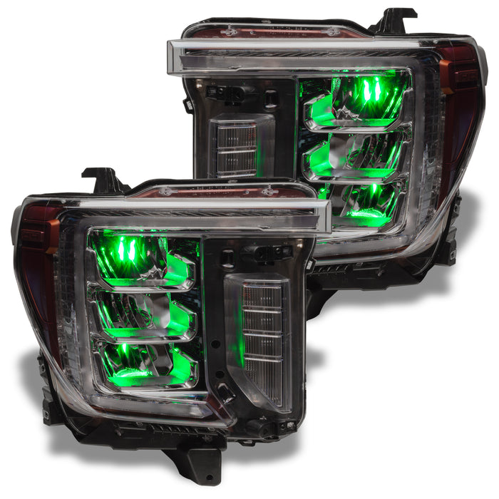 GMC Sierra headlights with green demon eye projectors.