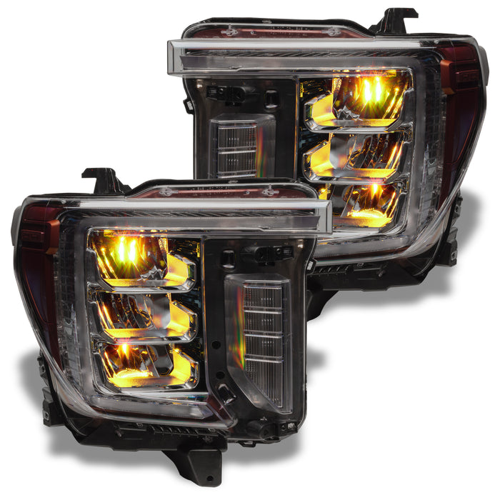 GMC Sierra headlights with yellow demon eye projectors.
