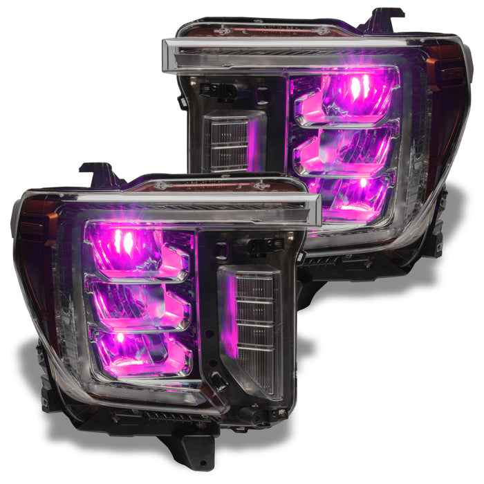 GMC Sierra headlights with pink demon eye projectors.