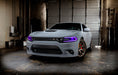Three quarters view of a grey Dodge Charger with purple headlight DRLs.