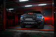 Front view of a Ram 1500 with blue headlight DRLs and green demon eye projectors.