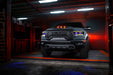 Front view of a Ram 1500 with yellow headlight DRLs and purple demon eye projectors.