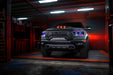 Front view of a Ram 1500 with purple headlight DRLs and cyan demon eye projectors.