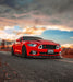 Lifestyle image of red mustang with white halos and DRL