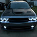 Silver dodge challenger with white headlight and fog light halos