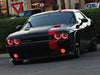 Black dodge challenger with red headlight and fog light halos