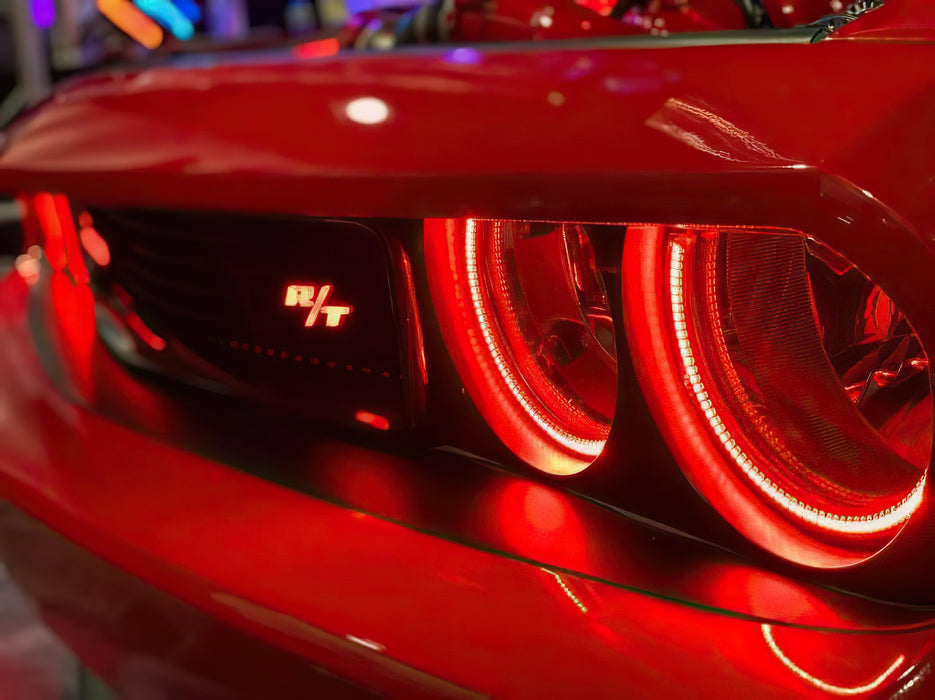 Close-up of red dodge challenger with red halo headlights