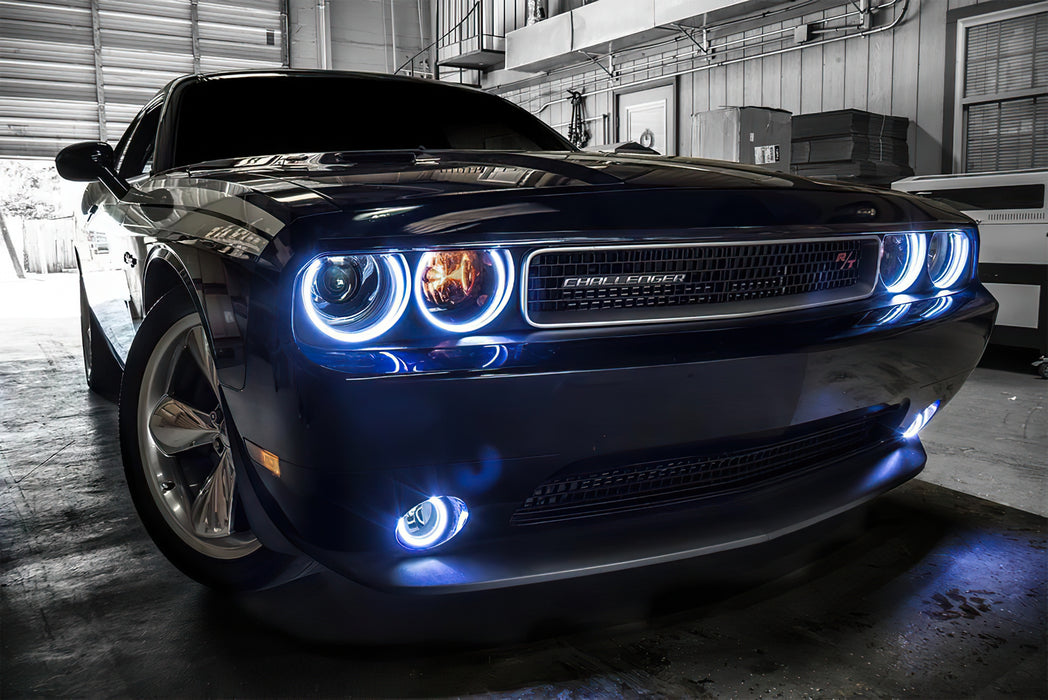 Front end of a Dodge Challenger with white LED headlight and fog light halos.