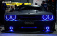 Front end of a Dodge Challenger with blue LED headlight and fog light halos.