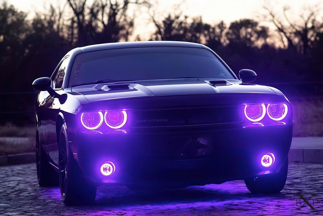 Front end of a Dodge Challenger with purple LED headlight and fog light halos.
