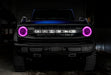 Front view of a blue Ford Bronco with pink headlight halos.