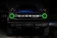 Front view of a blue Ford Bronco with green halos and DRLs.