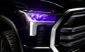 Close-up of a 2022+ Toyota Tundra headlight module installed with purple demon eye projector.