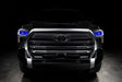  Straight front view of a black Toyota Tundra with blue demon eye projectors.