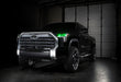 Three quarters view of a black Toyota Tundra with green demon eye projectors.