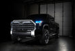 Three quarters view of a black Toyota Tundra with cyan demon eye projectors.