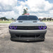 Front view of a grey Dodge Challenger with purple LED headlight halo rings installed.