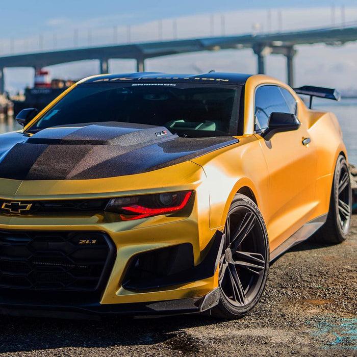 Gold camaro by the beach with red DRL