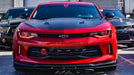 Front end of a red Chevrolet Camaro with red headlight and fog light DRLs.