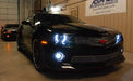 Front view of a Chevrolet Camaro with white LED headlight and fog light halo rings installed.