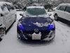 Front end of a Mazda 3 with blue LED headlight halo rings.