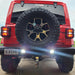 Rear end of a Jeep Wrangler JL with bright LED reverse lights on.