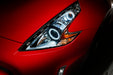 Nissan 370Z headlight with white LED halo rings installed.