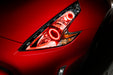Nissan 370Z headlight with red LED halo rings installed.