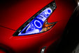 Nissan 370Z headlight with blue LED halo rings installed.