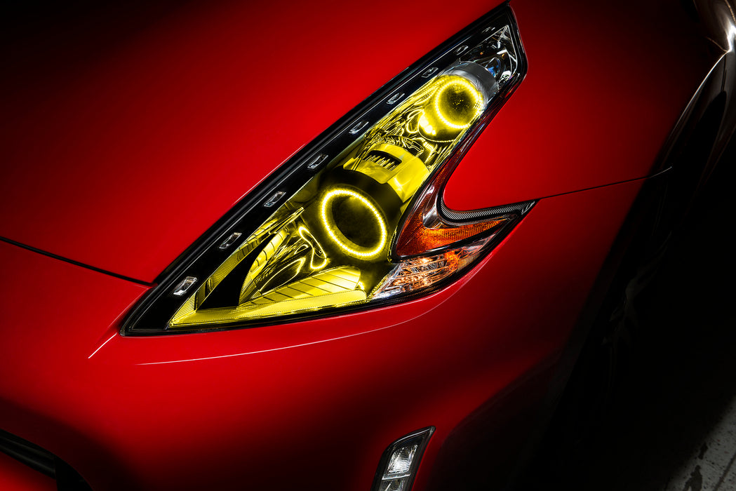 Nissan 370Z headlight with yellow LED halo rings installed.