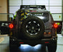 Rear veiw of Camo FJ Cruiser with ORACLE Lighting halos installed on tail lights