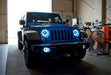 Three quarters view of a Jeep Wrangler JK with white LED headlight and fog light halo rings installed.