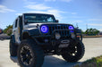 Three quarters view of a Jeep Wrangler JK with blue LED headlight halos installed.