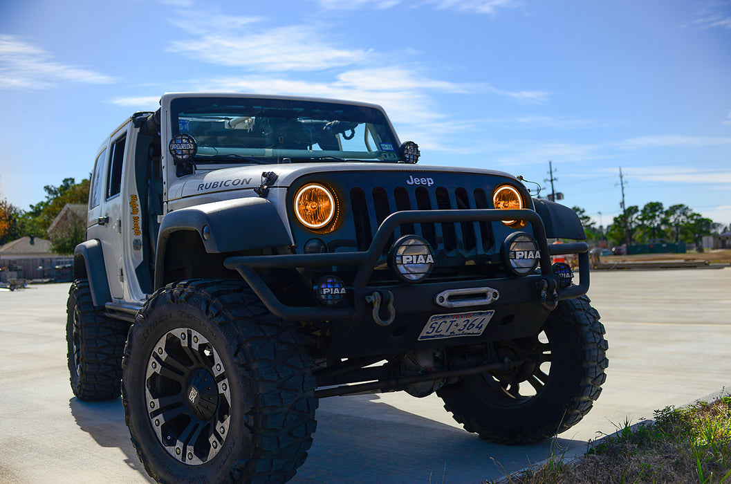 Three quarters view of a Jeep Wrangler JK with amber LED headlight halos installed.