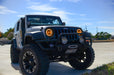 Three quarters view of a Jeep Wrangler JK with amber LED headlight halos installed.