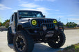 Three quarters view of a Jeep Wrangler JK with yellow LED headlight halos installed.