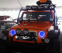 Front end of a Jeep Wrangler JK with blue LED headlight halos installed.
