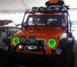 Front end of a Jeep Wrangler JK with green LED headlight halos installed.