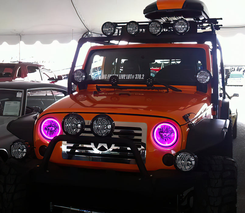 Front end of a Jeep Wrangler JK with pink LED headlight halos installed.