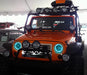 Front end of a Jeep Wrangler JK with cyan LED headlight halos installed.
