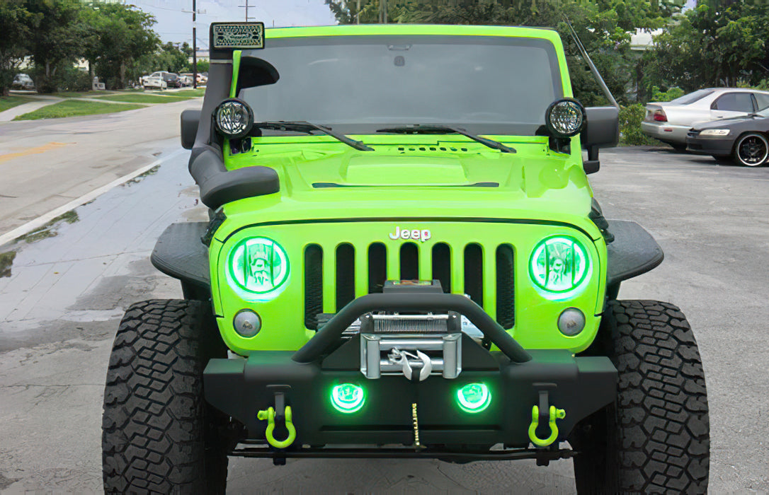 Front end of a Jeep Wrangler with green LED headlight and fog light halos installed.