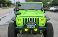 Front end of a Jeep Wrangler with yellow LED headlight and fog light halos installed.