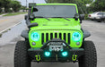 Front end of a Jeep Wrangler JK with cyan LED headlight and fog light halos.