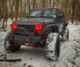 Three quarters view of a Jeep Wrangler JK with red LED headlight halos installed.