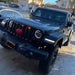 Front end of a Jeep Wrangler with amber LED Grill Light Kit installed.