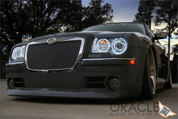 Front end of a Chrysler 300C with white LED headlight halo rings installed.